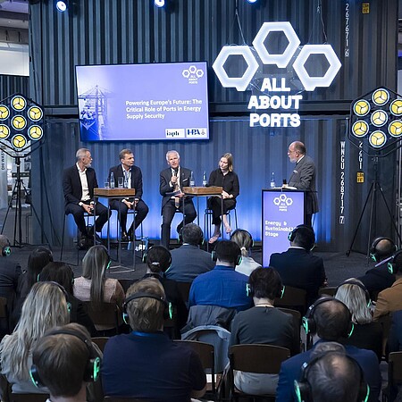 Podiumsdiskussion auf der Messebühne „All About Ports“ vor Fachpublikum während einer Branchenveranstaltung.